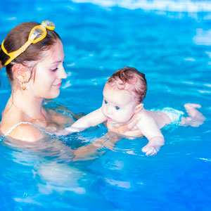 Mother Giving Swim Lesson to Toddler