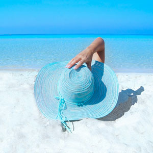 Woman With Sky Blue Hat Lying on Beach