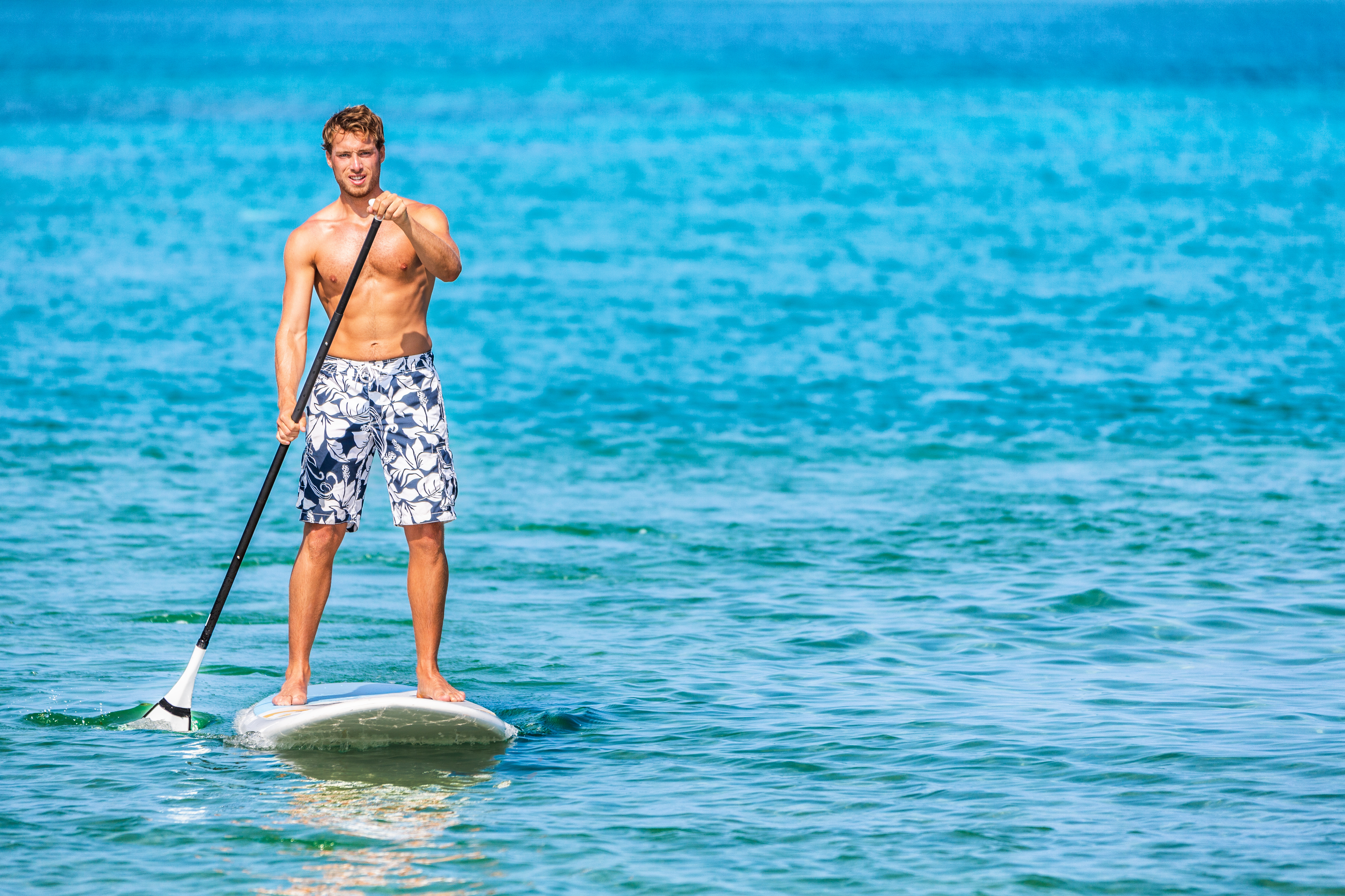 Man Standing on Paddleboard