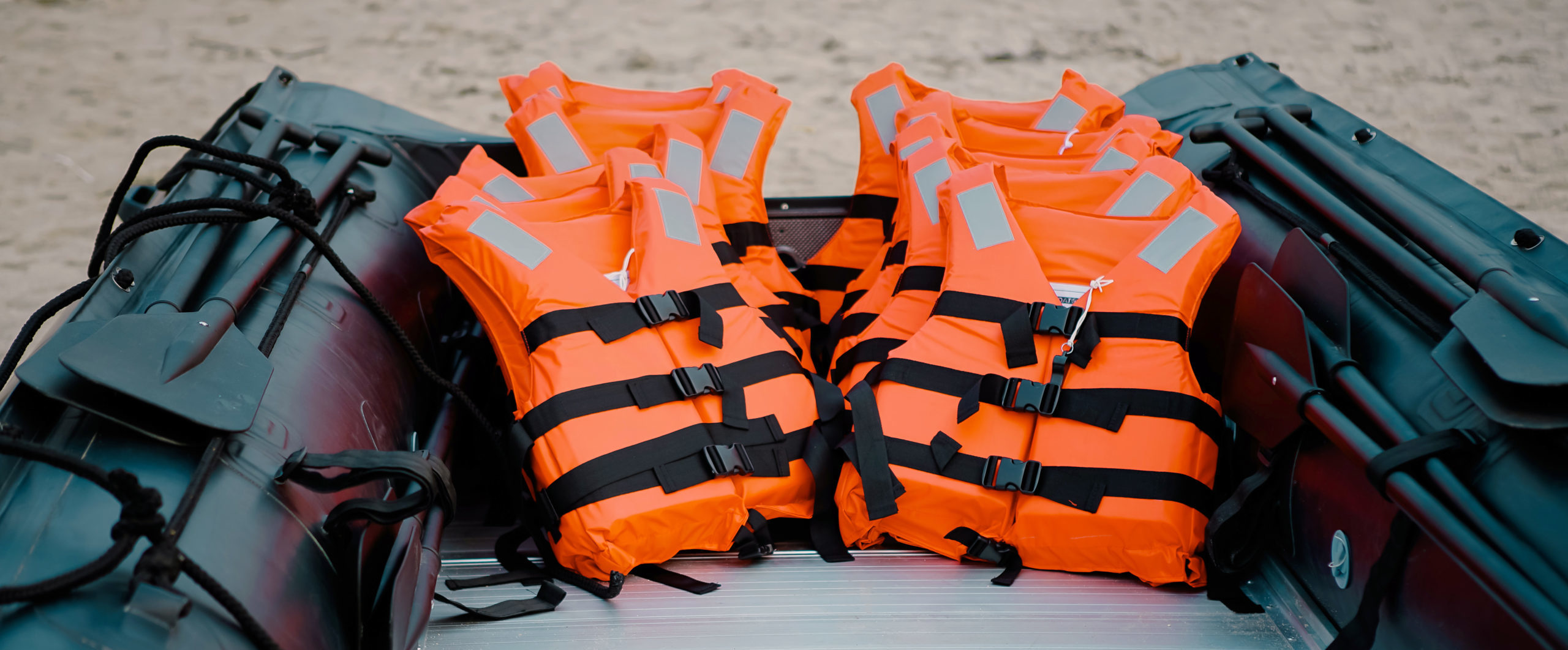 Life Jackets in Boat at Beach