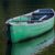 Green canoe on the water
