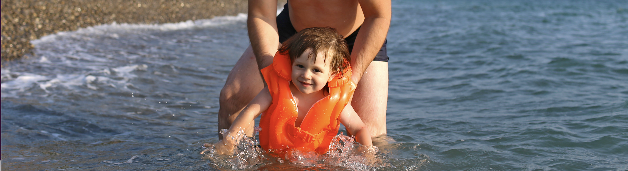 Kid Wearing Infant Life Jacket With His Father
