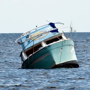 Blue Boat Overturns in Ocean