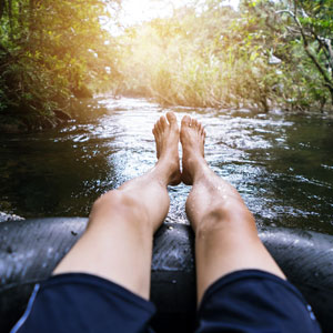 View of Legs of Man in River Tube